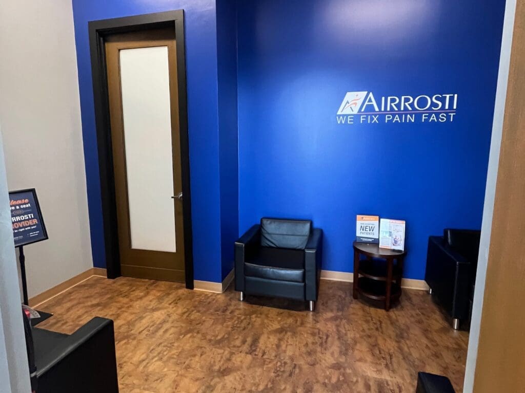 A view of the interior lobby at Airrosti Fairfield Village. The interior door to the practice is visible.