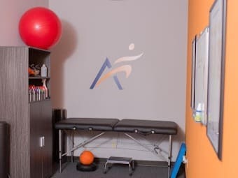 A photo of the interior recovery room at Airrosti Fairfield Village. an exercise ball and exercise table is featured.