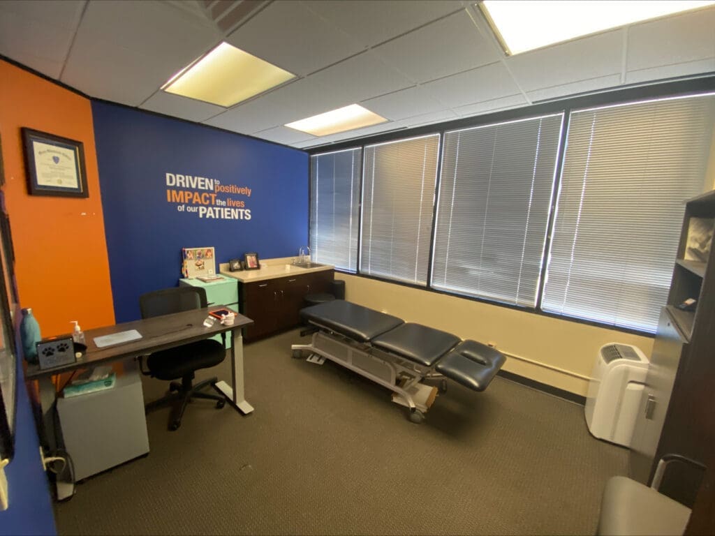 an interior photo of the treatment room at Airrosti West U. The treatment table is featured in the middle of the room.