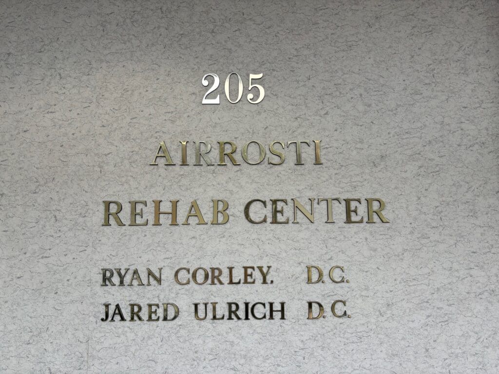 a close up photo of the name plate located right by the interior front entrance of Airrosti Rockwall