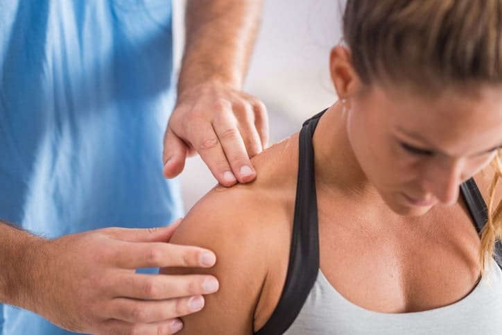 Woman getting shoulder worked on