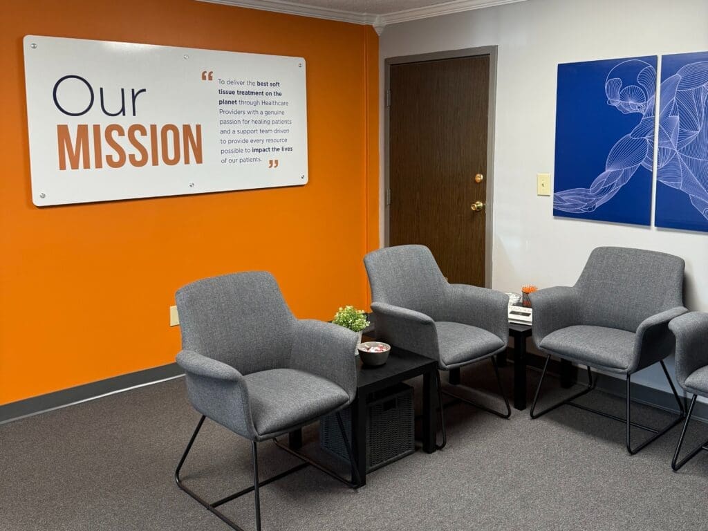 Interior view of the lobby at Airrosti Beechmont. Airrosti signage on the wall.