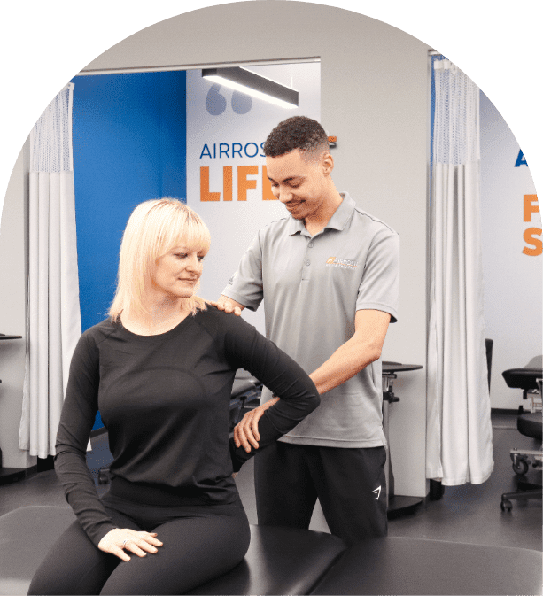 In-Clinic Care - Airrosti Provider treating a patient with arm pain